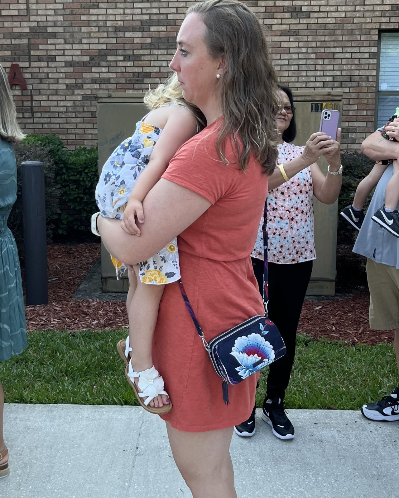 Jen of Moms Fit Life showing how to properly hold a toddler