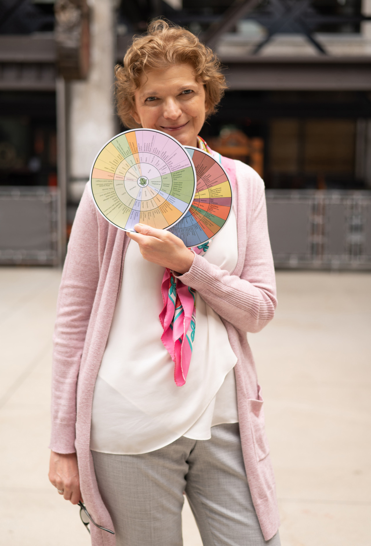 Isabelle Lesschaeve, wine tasting coach, showing two wine aroma wheels
